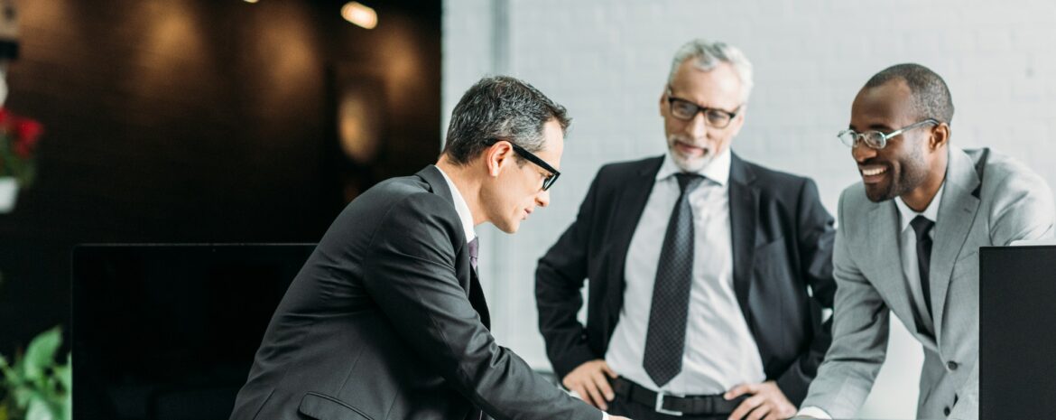multiethnic businessmen discussing new business strategy on meeting in office