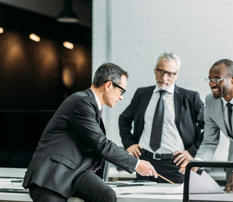 multiethnic businessmen discussing new business strategy on meeting in office