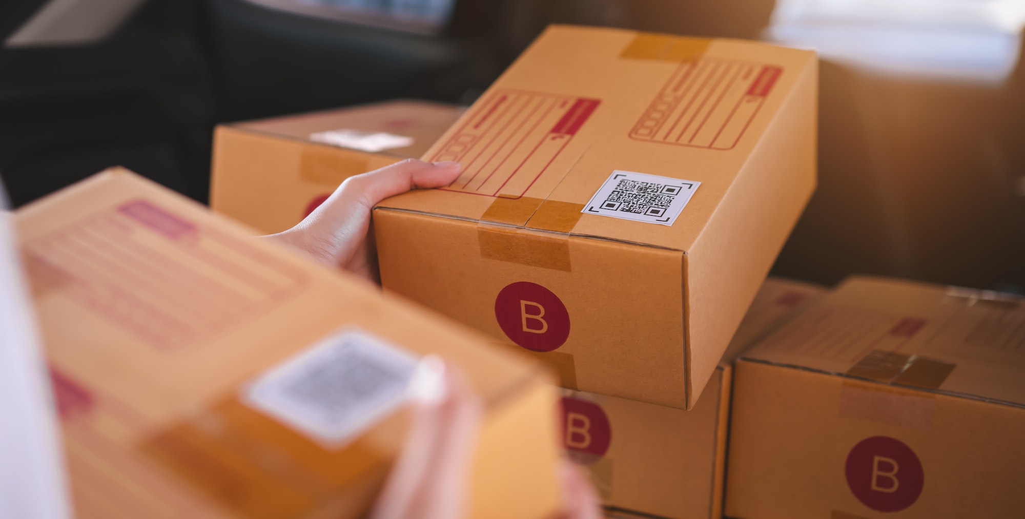 Startup small business, hand packing boxes for products to send to customers.